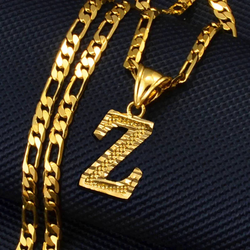 Gold plated initial alphabet pendant on Figaro chain necklace for women, men, and girls.