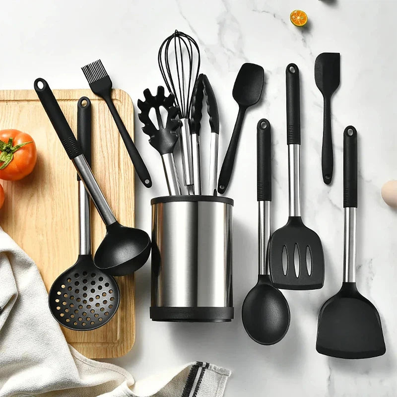 12-piece silicone kitchenware set with stainless steel handles in a rotating storage bucket, includes spatula, soup spoon, and eggbeater.