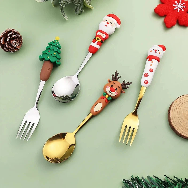 Christmas cutlery set with creative cartoon doll designs featuring Santa, snowman, tree, and reindeer on stainless steel dessert spoons and forks.