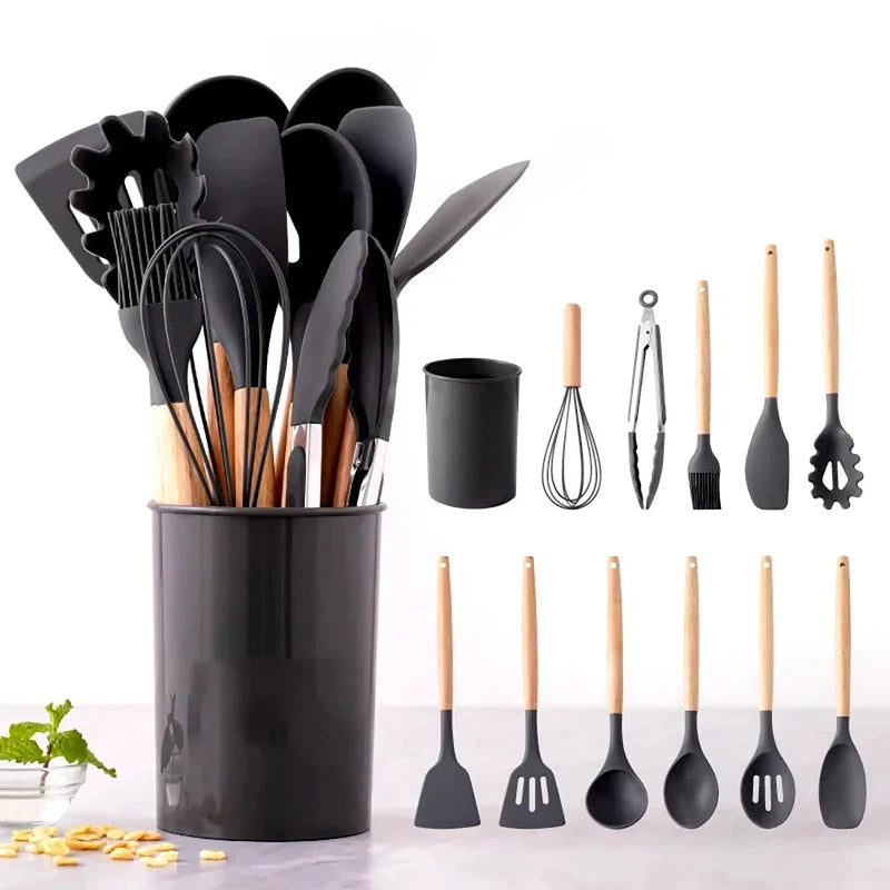 12-piece silicone kitchen utensil set with wooden handles in a black storage bucket.