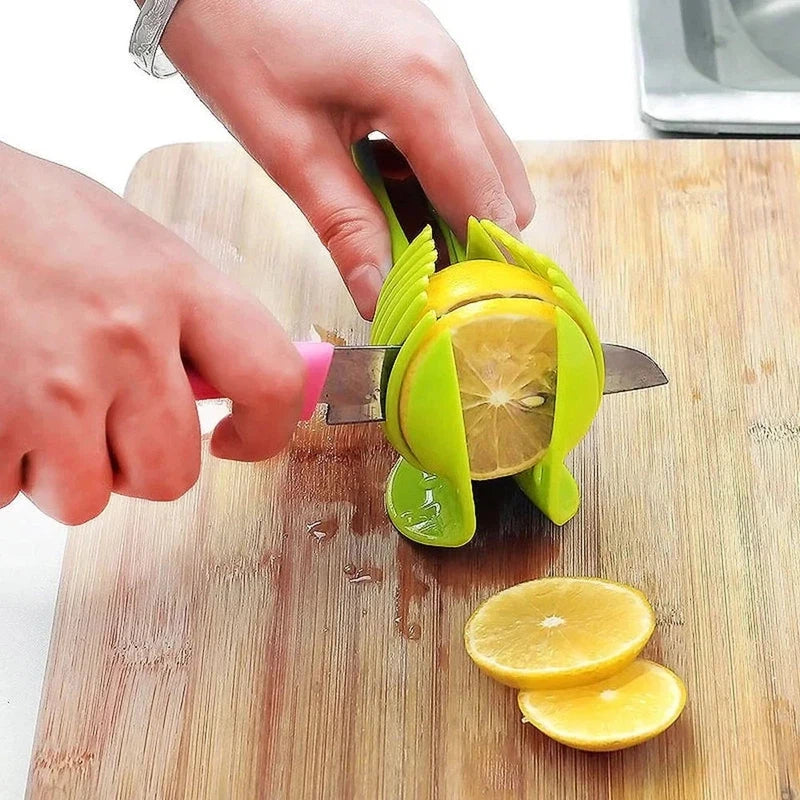 Stainless steel lemon slicer tool for kitchen use, slicing a lemon on a wooden cutting board.