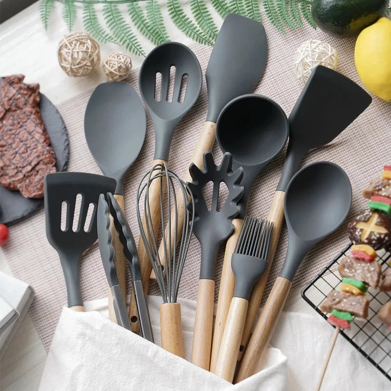 12-piece non-stick silicone kitchen utensil set with wooden handles, including spatula, shovel, and egg beaters.